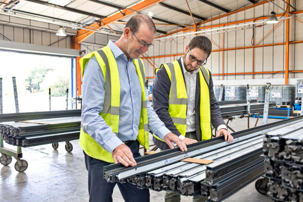 Thumbnail photo in factory showing aluminium profiles being insepcted